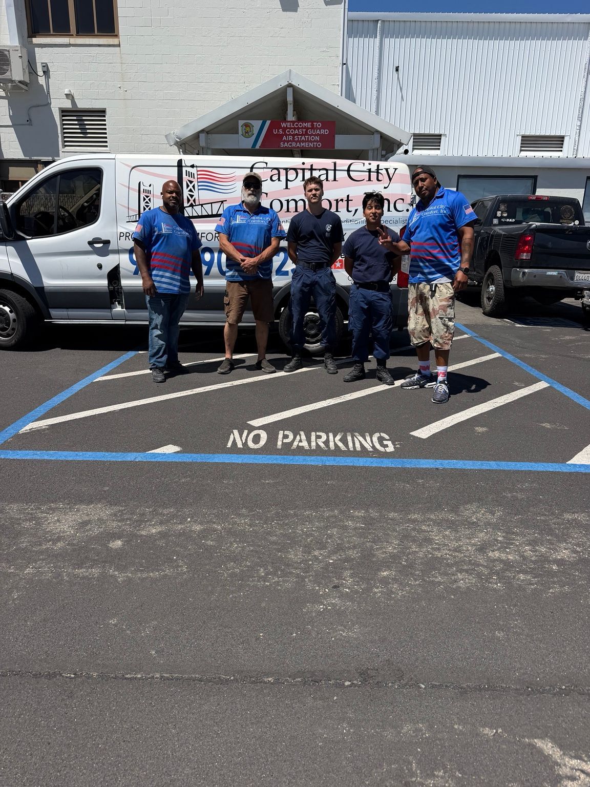 Capital City Comfort team and Coast Guard personnel beside the company van at Air Station Sacramento